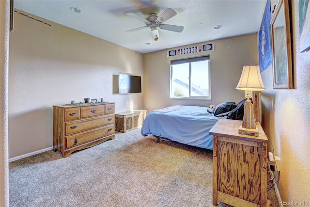 bedroom featuring light colored carpet and ceiling fan