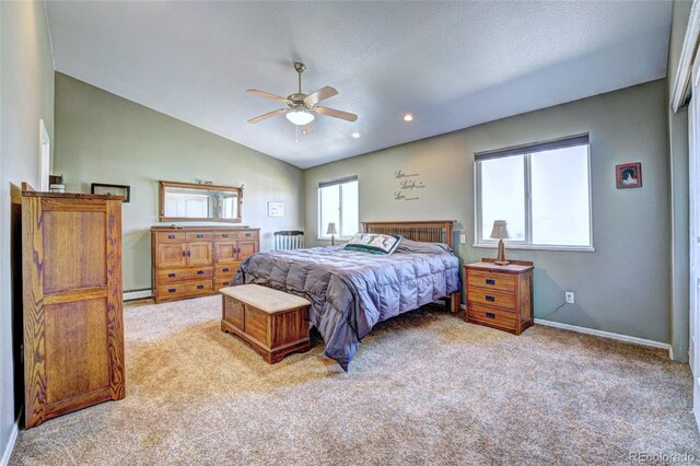 bedroom with a baseboard heating unit, a textured ceiling, ceiling fan, vaulted ceiling, and light colored carpet