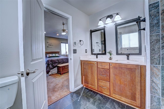 bathroom featuring toilet, vanity, and ceiling fan