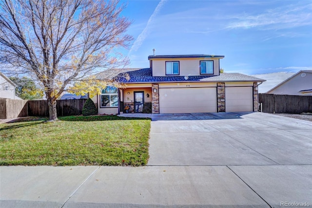 front of property with a front lawn and a garage