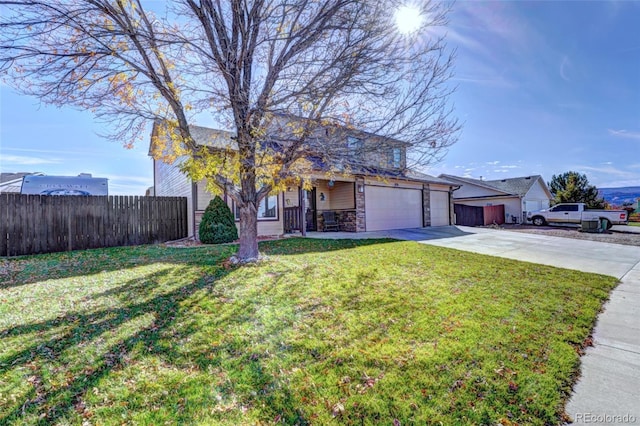 view of front of home with a front yard, a garage, and covered porch