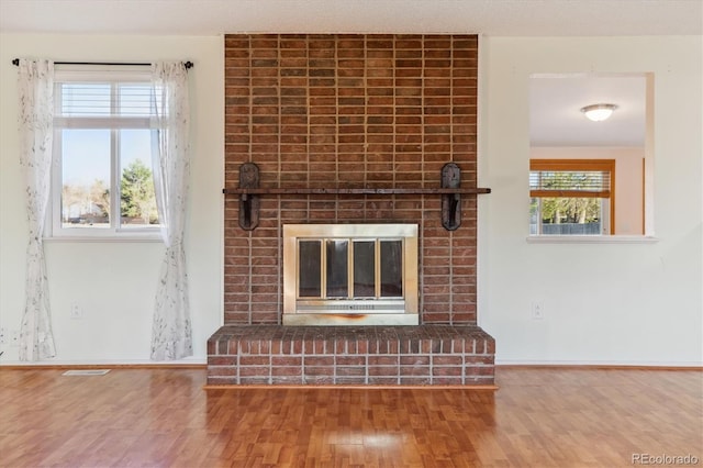 16246 E Hamilton Pl, Aurora, CO 80013 - detailed view of a brick fireplace, wood finished floors, and baseboards
