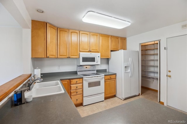 16246 E Hamilton Pl, Aurora, CO 80013 - kitchen with white appliances, a sink, and dark countertops