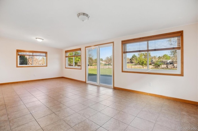 16246 E Hamilton Pl, Aurora, CO 80013 - unfurnished room featuring baseboards, light tile patterned floors, and lofted ceiling