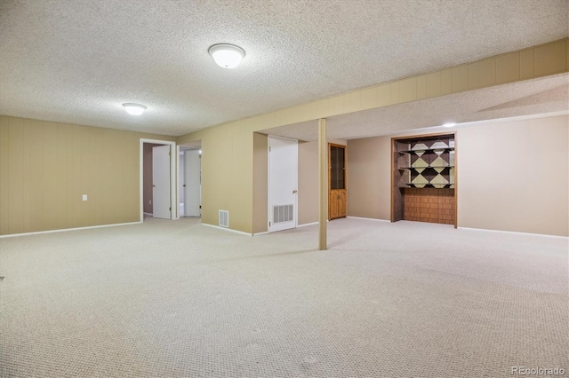 16246 E Hamilton Pl, Aurora, CO 80013 - finished below grade area featuring a textured ceiling, carpet, and baseboards