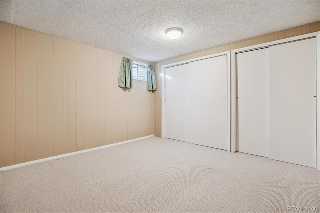 16246 E Hamilton Pl, Aurora, CO 80013 - unfurnished bedroom with two closets, carpet flooring, and a textured ceiling