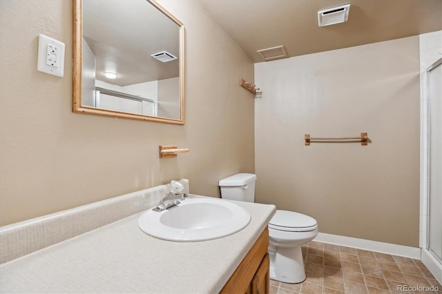 16246 E Hamilton Pl, Aurora, CO 80013 - bathroom with toilet, an enclosed shower, vanity, and baseboards