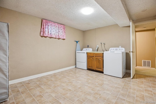 16246 E Hamilton Pl, Aurora, CO 80013 - laundry area featuring a textured ceiling, baseboards, cabinet space, and washer and dryer