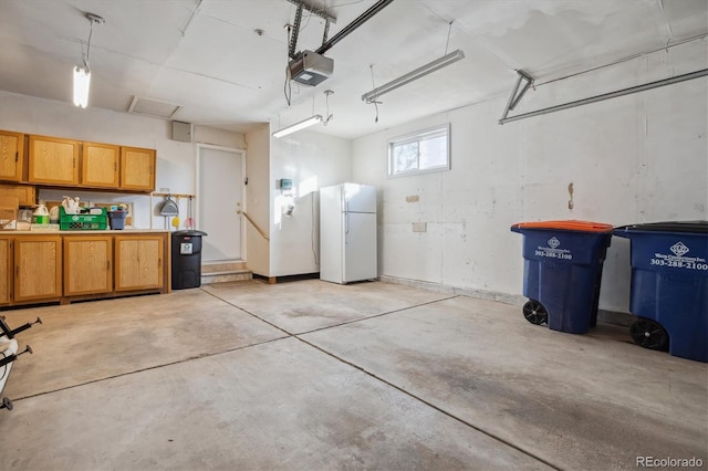 16246 E Hamilton Pl, Aurora, CO 80013 - garage featuring freestanding refrigerator and a garage door opener