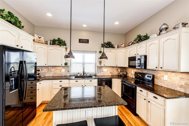 34942 Wagon Wheel Trl, Elizabeth, CO 80107 - kitchen with black appliances, a sink, light wood-style floors, dark stone countertops, and recessed lighting
