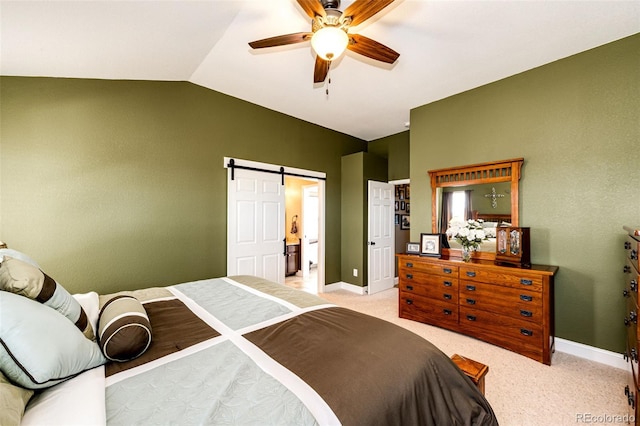 34942 Wagon Wheel Trl, Elizabeth, CO 80107 - bedroom with lofted ceiling, a barn door, light colored carpet, baseboards, and a ceiling fan