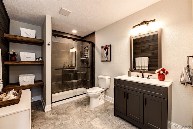 34942 Wagon Wheel Trl, Elizabeth, CO 80107 - bathroom featuring toilet, vanity, a shower stall, a textured ceiling, and baseboards