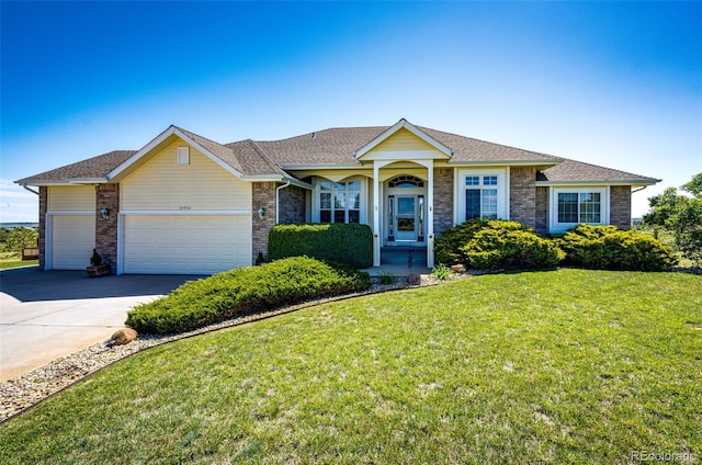 34942 Wagon Wheel Trl, Elizabeth, CO 80107 - ranch-style home featuring a front lawn, a garage, driveway, brick siding, and a shingled roof