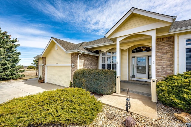 34942 Wagon Wheel Trl, Elizabeth, CO 80107 - single story home featuring concrete driveway, brick siding, roof with shingles, and an attached garage