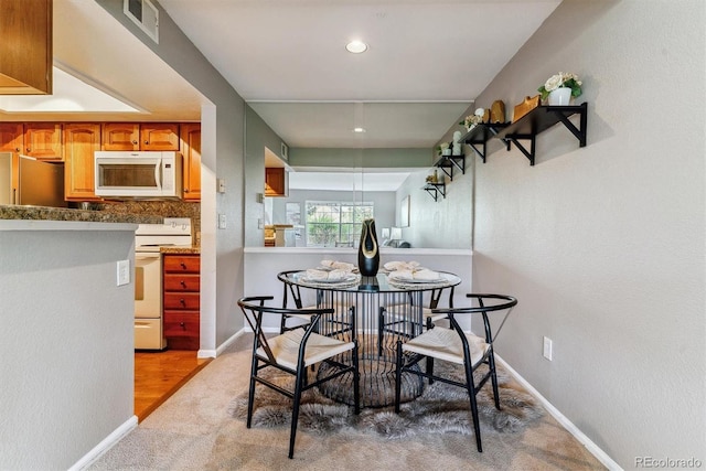 9283 E Arbor Cir Unit C, Englewood, CO 80111 - dining space featuring recessed lighting, light carpet, and light wood-style flooring