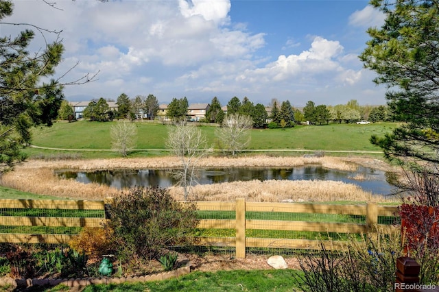 exterior space featuring fence and a water view