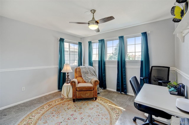 carpeted office with baseboards and ceiling fan