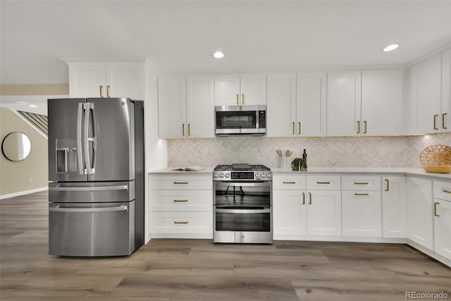 1980 S Kearney Way, Denver, CO 80224 - kitchen featuring appliances with stainless steel finishes, white cabinetry, light countertops, backsplash, and recessed lighting