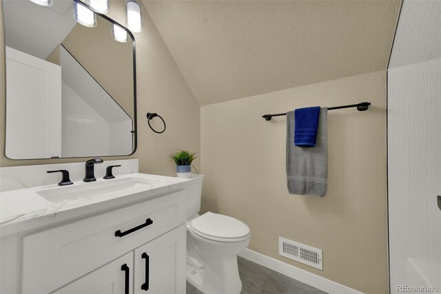 1980 S Kearney Way, Denver, CO 80224 - bathroom with vanity, vaulted ceiling, and tile patterned floors