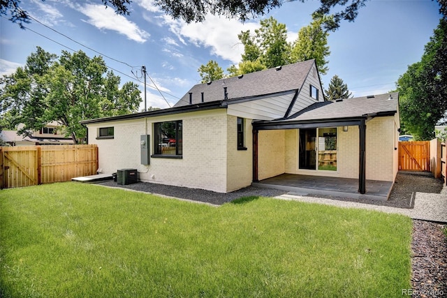 1980 S Kearney Way, Denver, CO 80224 - back of house with a patio, a fenced backyard, brick siding, a gate, and roof with shingles