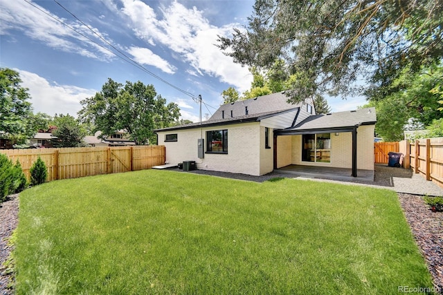 1980 S Kearney Way, Denver, CO 80224 - rear view of property with a fenced backyard, a patio, and brick siding