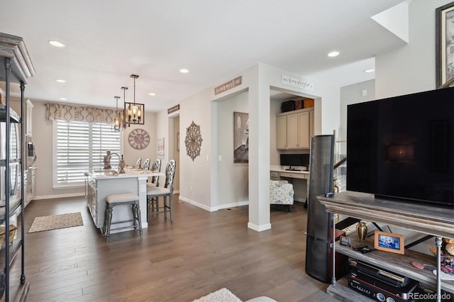 living room with a notable chandelier and dark hardwood / wood-style flooring