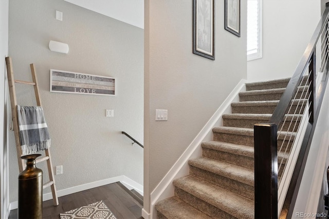 stairs with hardwood / wood-style floors