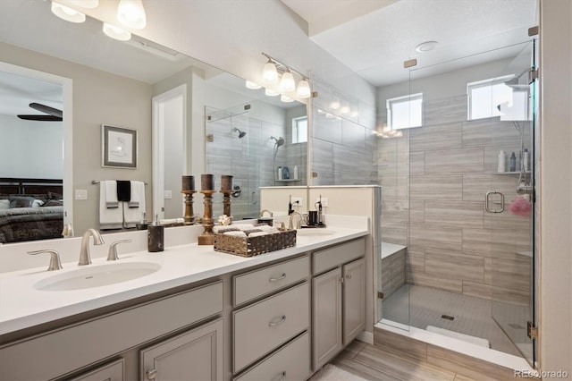 bathroom featuring vanity, wood-type flooring, and walk in shower