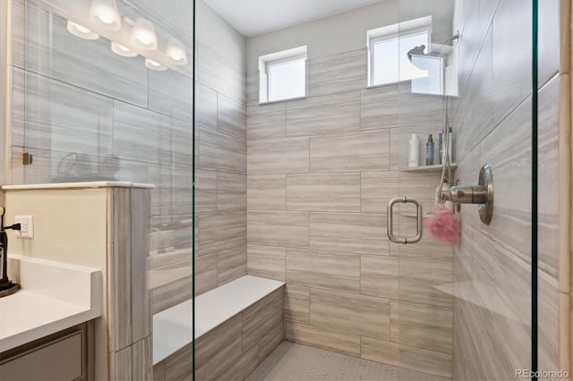 bathroom with vanity and a shower with shower door