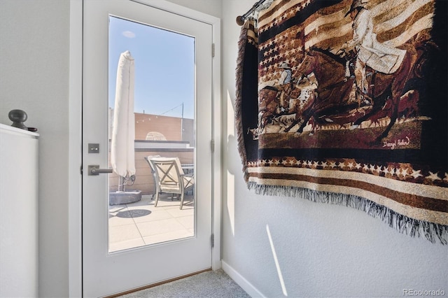 doorway to outside with carpet