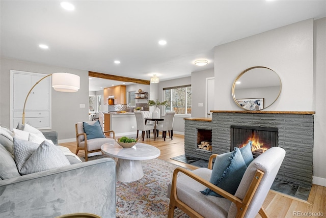 1295 Elm St, Denver, CO 80220 - living room with a fireplace, light wood-style flooring, and recessed lighting