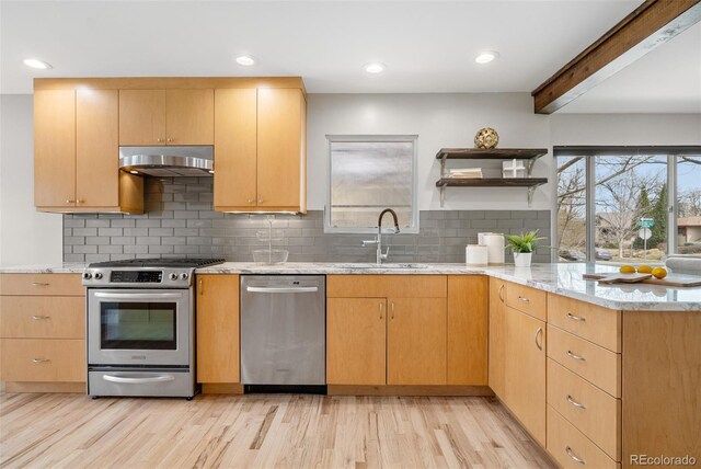 1295 Elm St, Denver, CO 80220 - kitchen with stainless steel appliances, under cabinet range hood, light stone countertops, light wood-style flooring, and beam ceiling