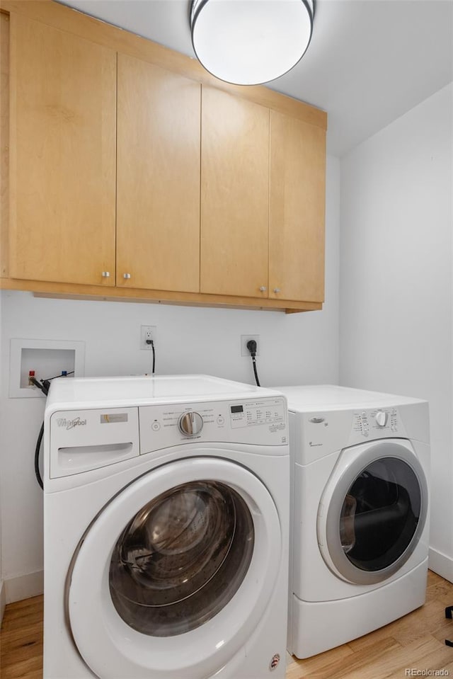 1295 Elm St, Denver, CO 80220 - laundry area with cabinet space, separate washer and dryer, and light wood-type flooring