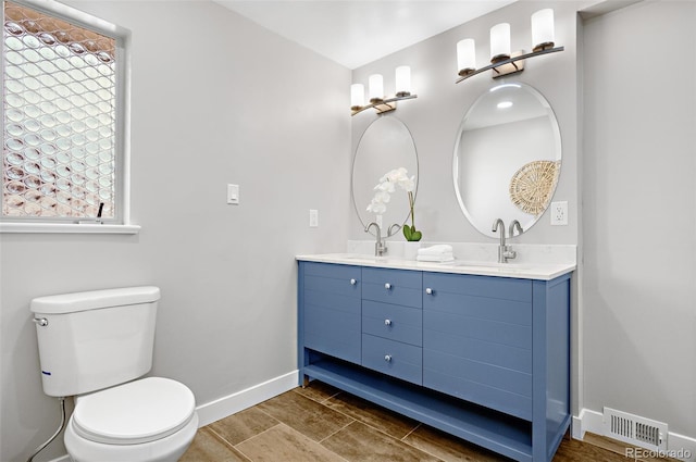 1295 Elm St, Denver, CO 80220 - bathroom featuring double vanity and wood finished floors