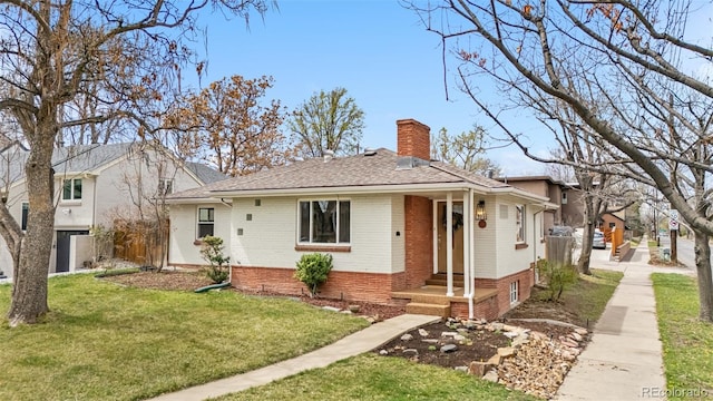 1295 Elm St, Denver, CO 80220 - view of front of property featuring brick siding, a chimney, and a shingled roof