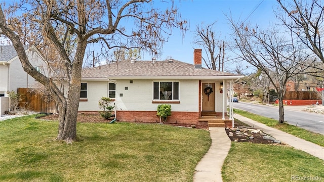 1295 Elm St, Denver, CO 80220 - view of front of property with a chimney, brick siding, and roof with shingles