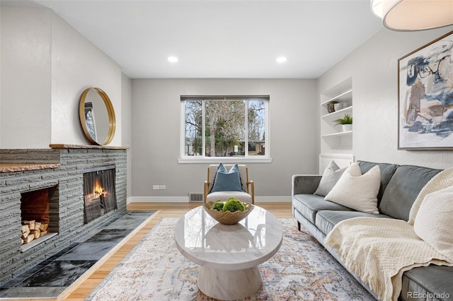 1295 Elm St, Denver, CO 80220 - living room featuring a fireplace, wood finished floors, recessed lighting, and built in features