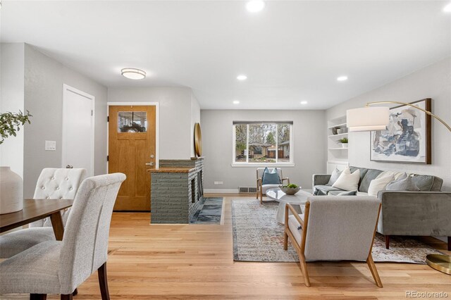 1295 Elm St, Denver, CO 80220 - living area featuring light wood finished floors, recessed lighting, and a fireplace