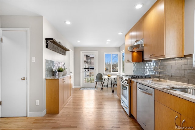 1295 Elm St, Denver, CO 80220 - kitchen featuring dishwasher, stove, under cabinet range hood, light wood finished floors, and recessed lighting