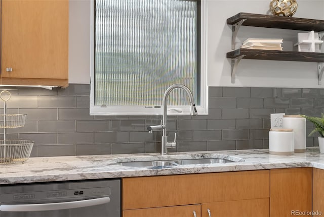 1295 Elm St, Denver, CO 80220 - kitchen featuring stainless steel dishwasher, tasteful backsplash, and light stone countertops