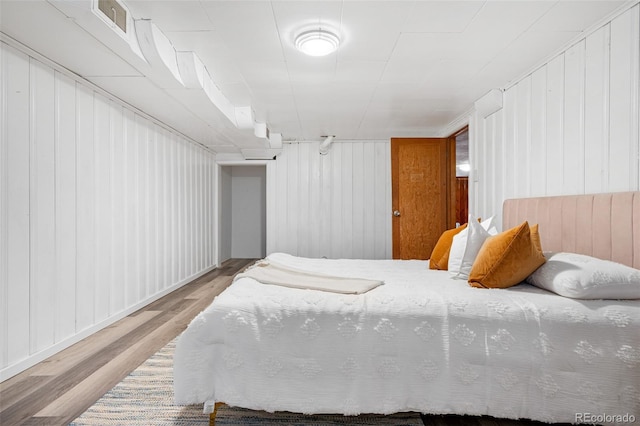 1295 Elm St, Denver, CO 80220 - bedroom featuring wood finished floors and wood walls