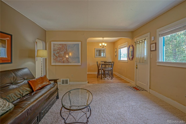 living room with a chandelier and light wood-type flooring