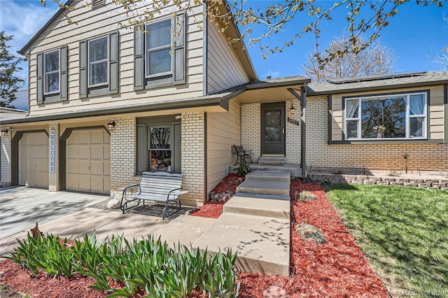 2023 S Rifle St, Aurora, CO 80013 - view of front of house with brick siding, an attached garage, and driveway