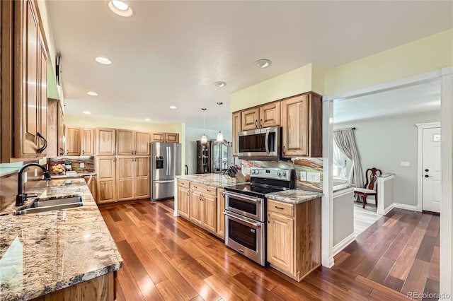 2023 S Rifle St, Aurora, CO 80013 - kitchen with stainless steel appliances, a sink, light stone counters, dark wood-style flooring, and recessed lighting