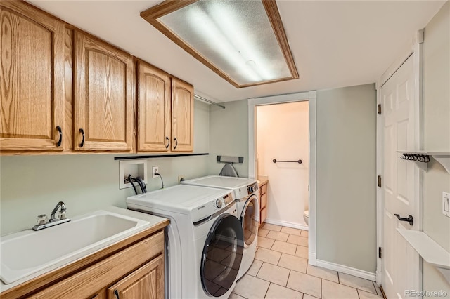 2023 S Rifle St, Aurora, CO 80013 - washroom with cabinet space, washer and dryer, light tile patterned floors, and baseboards