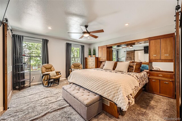 2023 S Rifle St, Aurora, CO 80013 - bedroom featuring carpet flooring, baseboards, recessed lighting, a barn door, and a ceiling fan