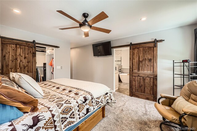 2023 S Rifle St, Aurora, CO 80013 - bedroom featuring a barn door, recessed lighting, a spacious closet, ensuite bathroom, and a closet