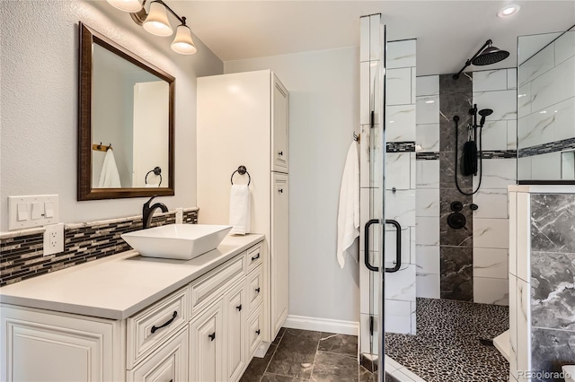 2023 S Rifle St, Aurora, CO 80013 - full bath with a stall shower, marble finish floors, vanity, backsplash, and baseboards