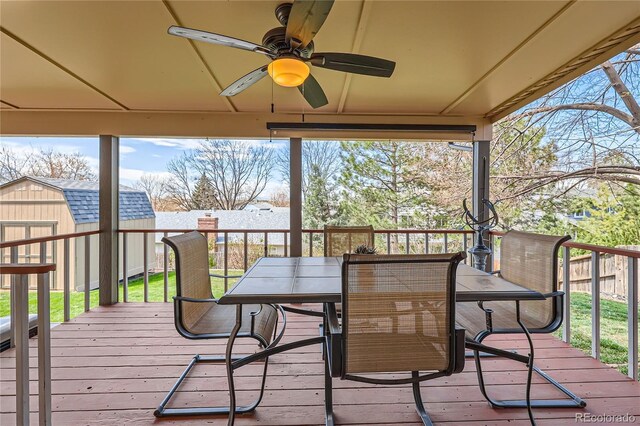 2023 S Rifle St, Aurora, CO 80013 - wooden terrace with a ceiling fan, a shed, an outbuilding, outdoor dining area, and fence