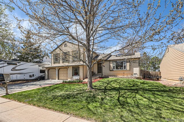 2023 S Rifle St, Aurora, CO 80013 - traditional home with brick siding, a garage, and driveway